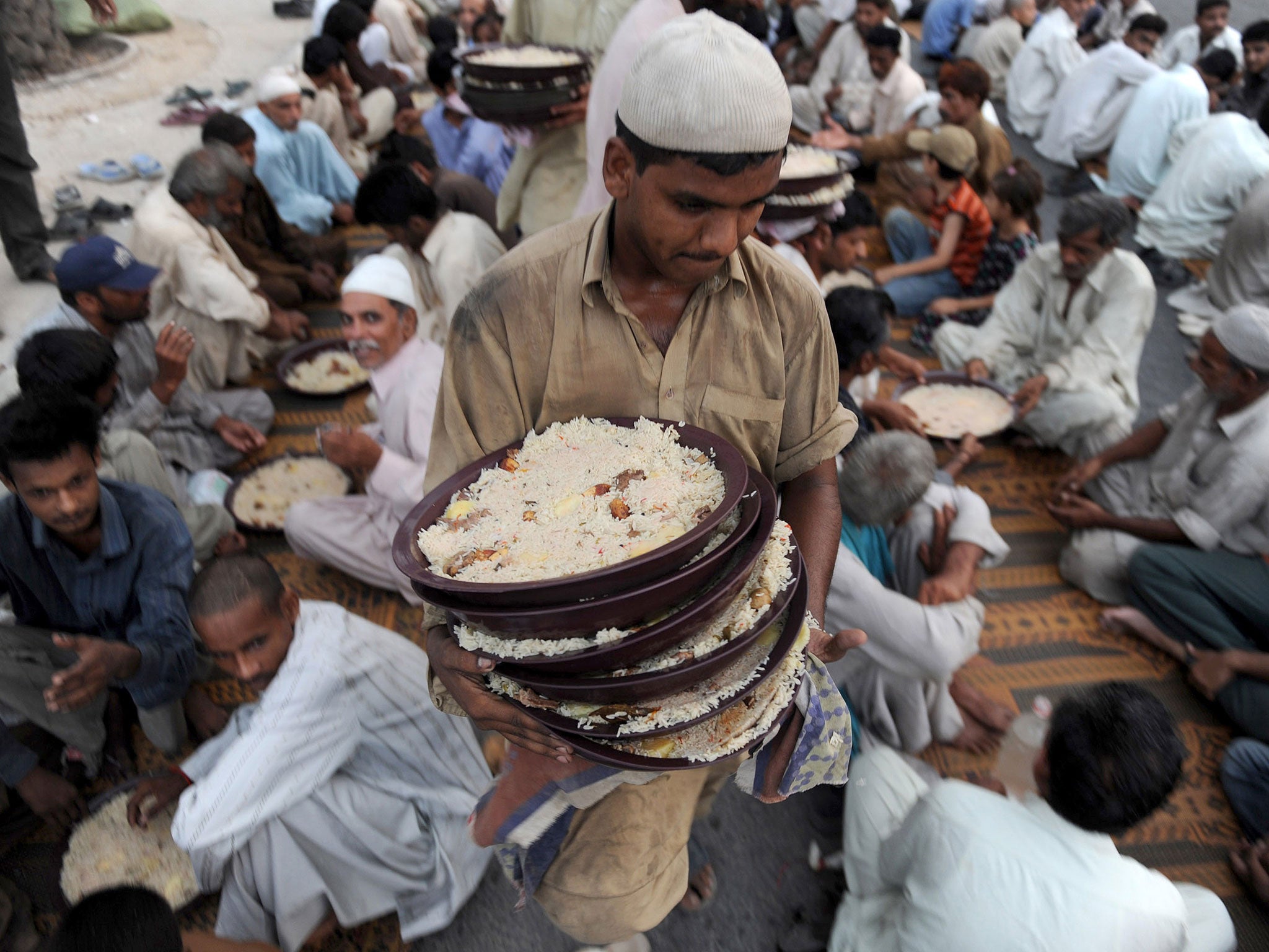 Food for thought: a Pakistani Muslim distributes food for Iftar, which breaks the fast at sunset