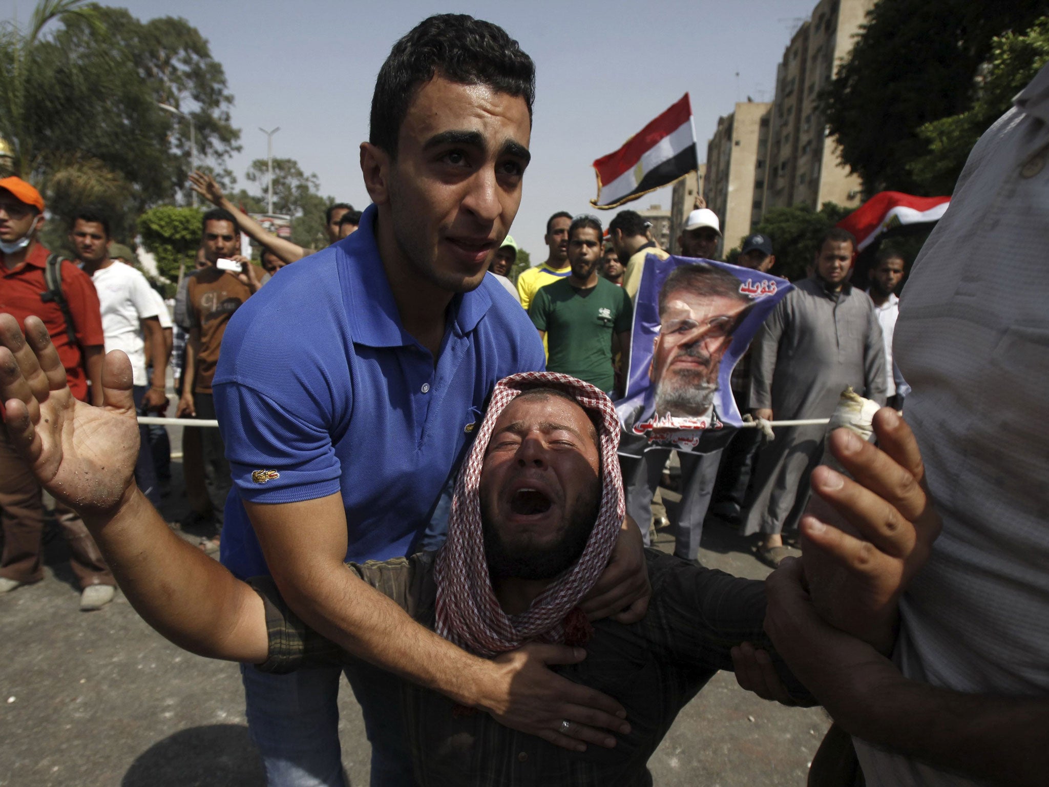 Members of the Muslim Brotherhood and supporters of Mohamed Morsi outside the Republican Guard headquarters in Cairo