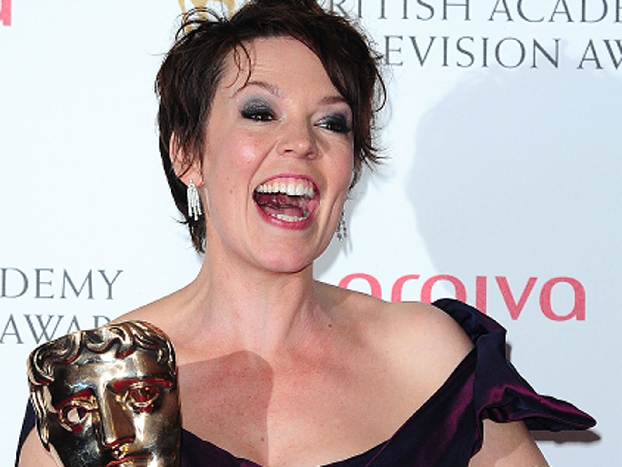 Olivia Colman with her awards for comedic and dramatic acting