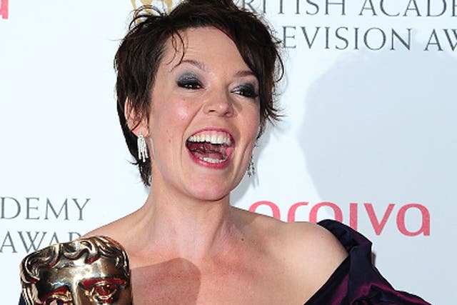 Olivia Colman with her awards for comedic and dramatic acting