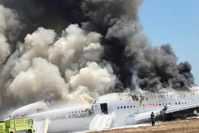Asiana Airlines Boeing 777 is engulfed on the tarmac after crash landing at San Francisco International Airport in San Francisco, California