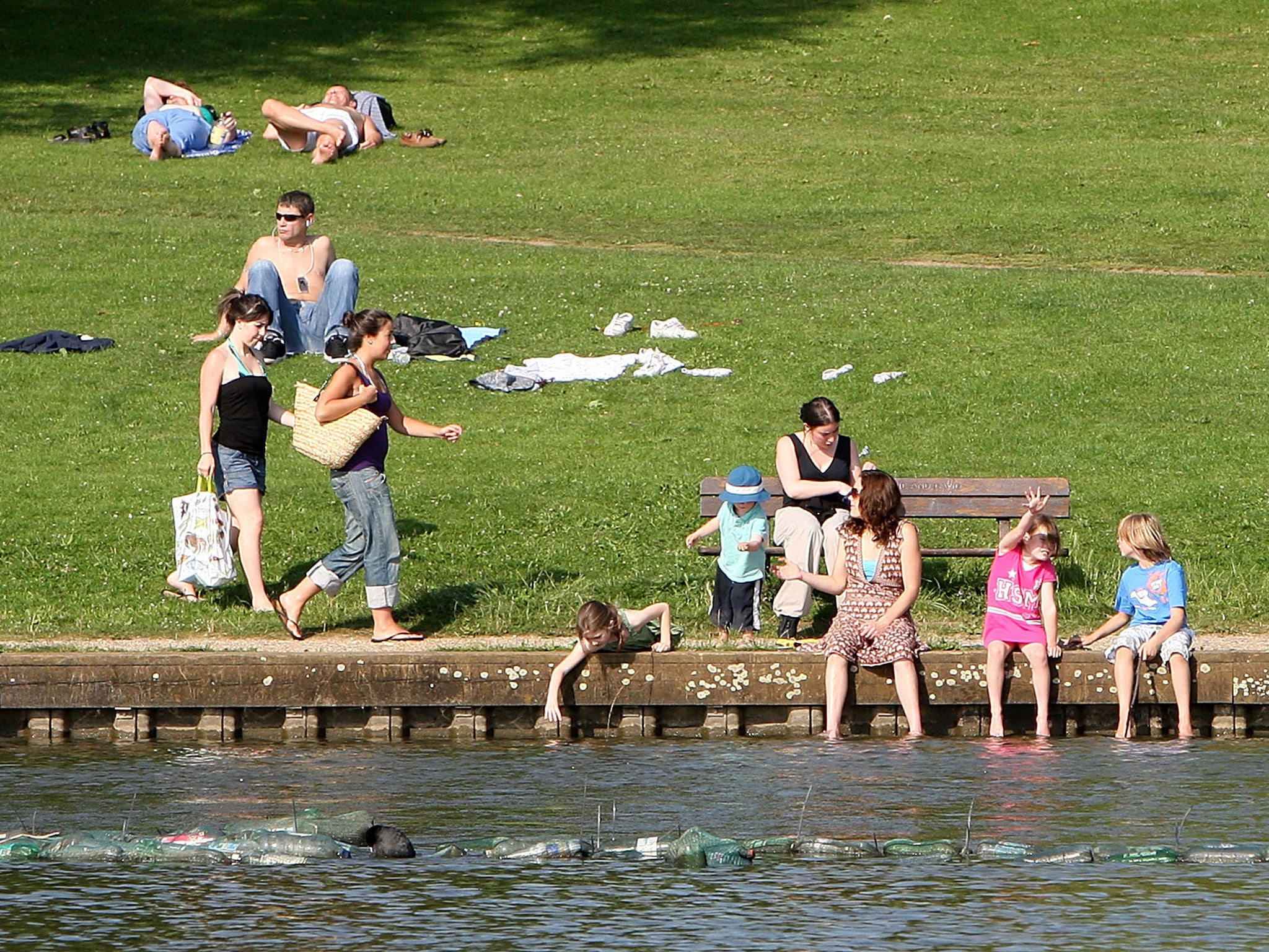 People sunbathe on Hampstead Heath on July 24, 2008 in London, England