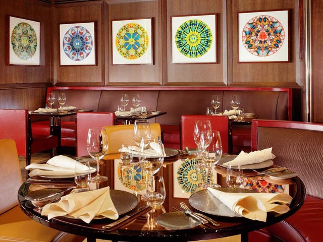 All 16 of Damien Hirst's limited edition Diamond Dust “Psalms” series hang in the restaurant