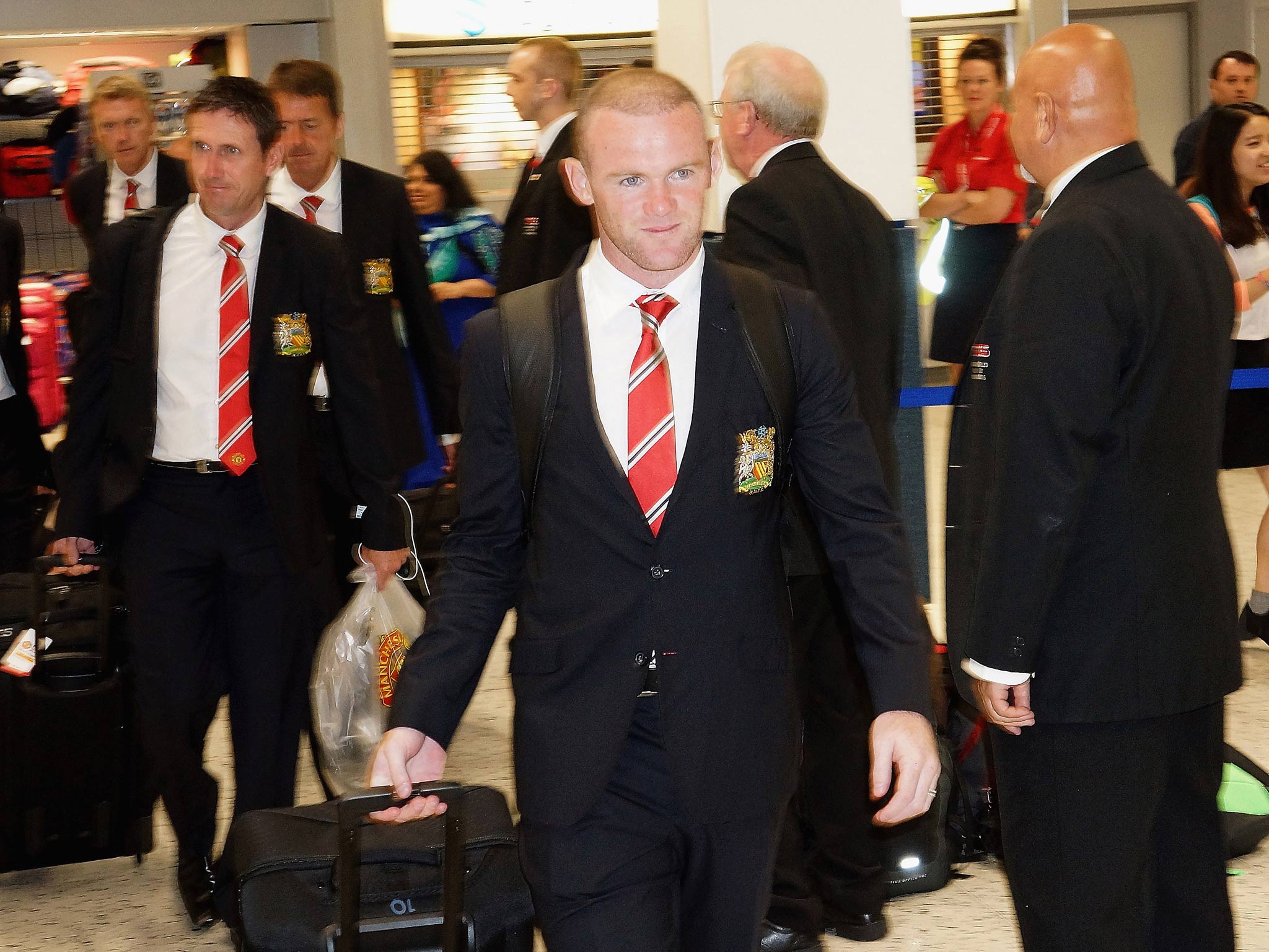 Wayne Rooney pictured checking in at Manchester Airport on Wednesday
