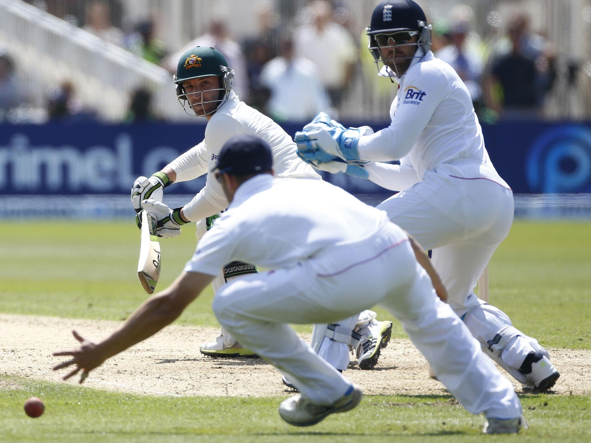 Phil Hughes steers the ball past England’s Matt Prior (right)