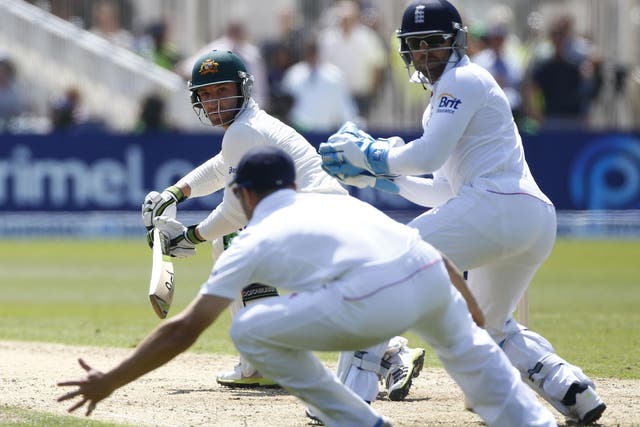 Phil Hughes steers the ball past England’s Matt Prior (right)