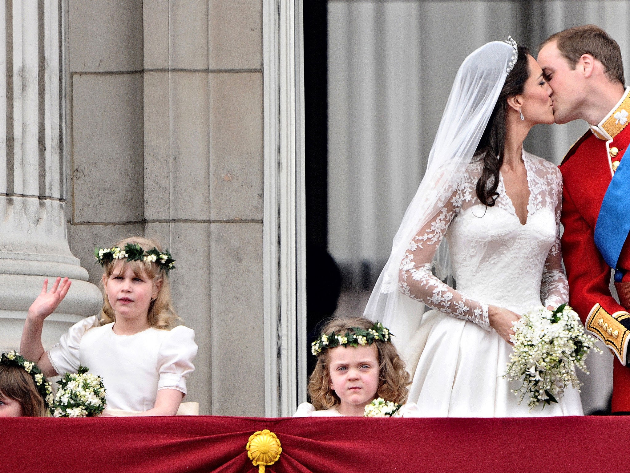 Britain's Prince William kisses his wife Kate, Duchess of Cambridge, on the balcony of Buckingham Palace, after the wedding service, on April 29, 2011, in London.