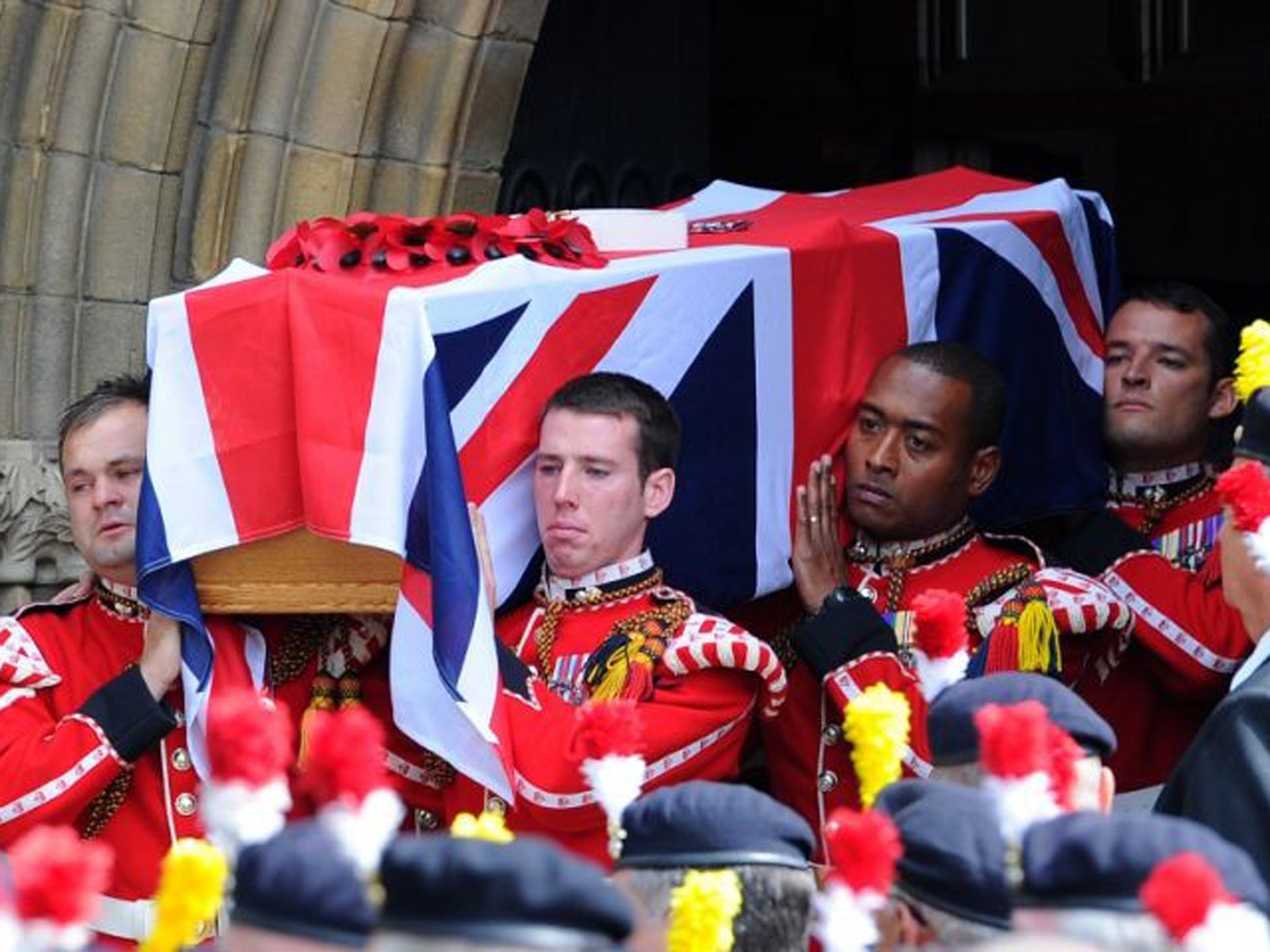 The coffin of murdered Fusilier Lee Rigby is carried by soldiers after his funeral service at Bury Parish church in Greater Manchester