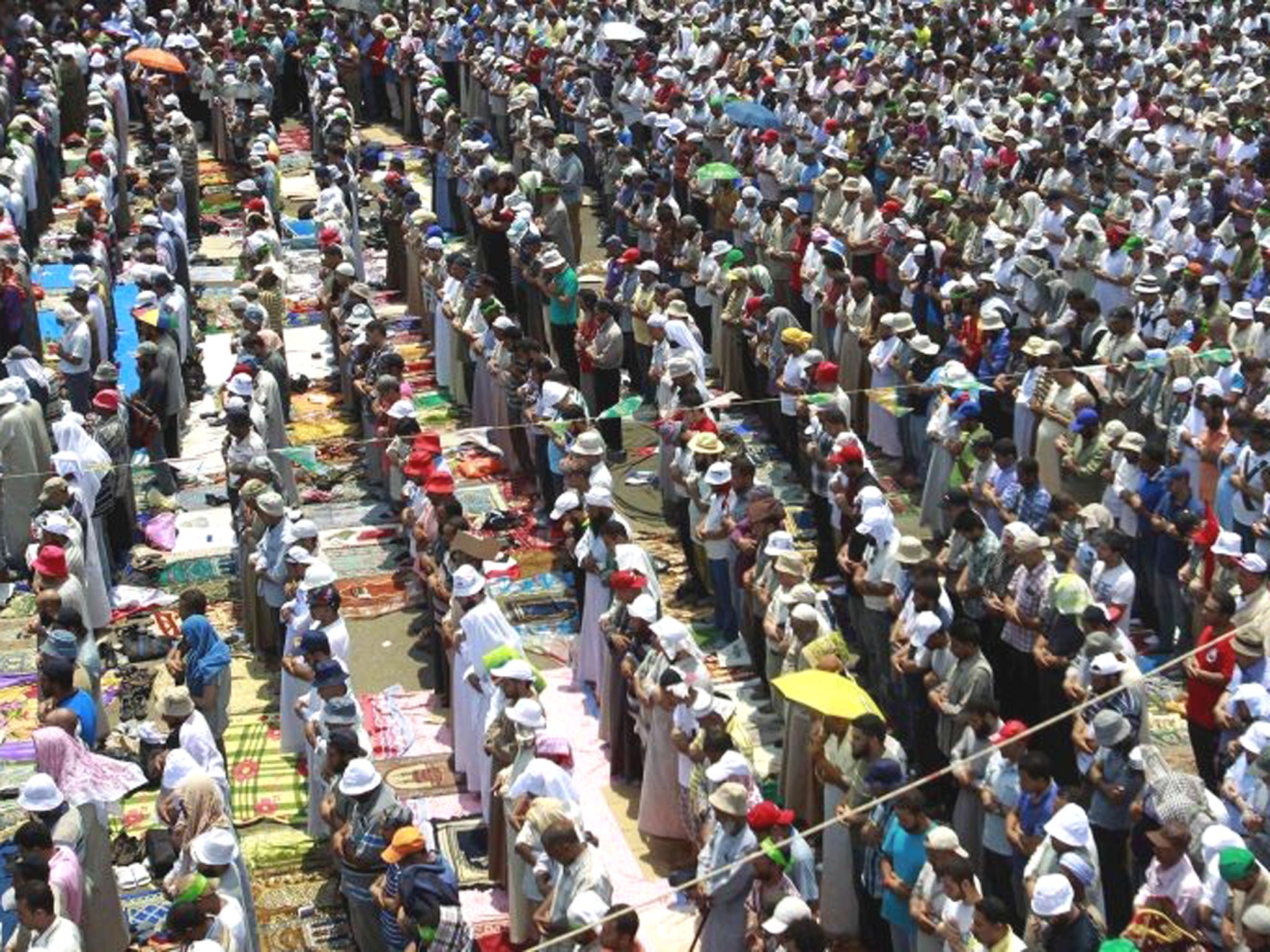 Supporters of ousted President Mohamed Morsi perform weekly Friday prayers at Rabaa Adawiya square, where they are camping, in Cairo