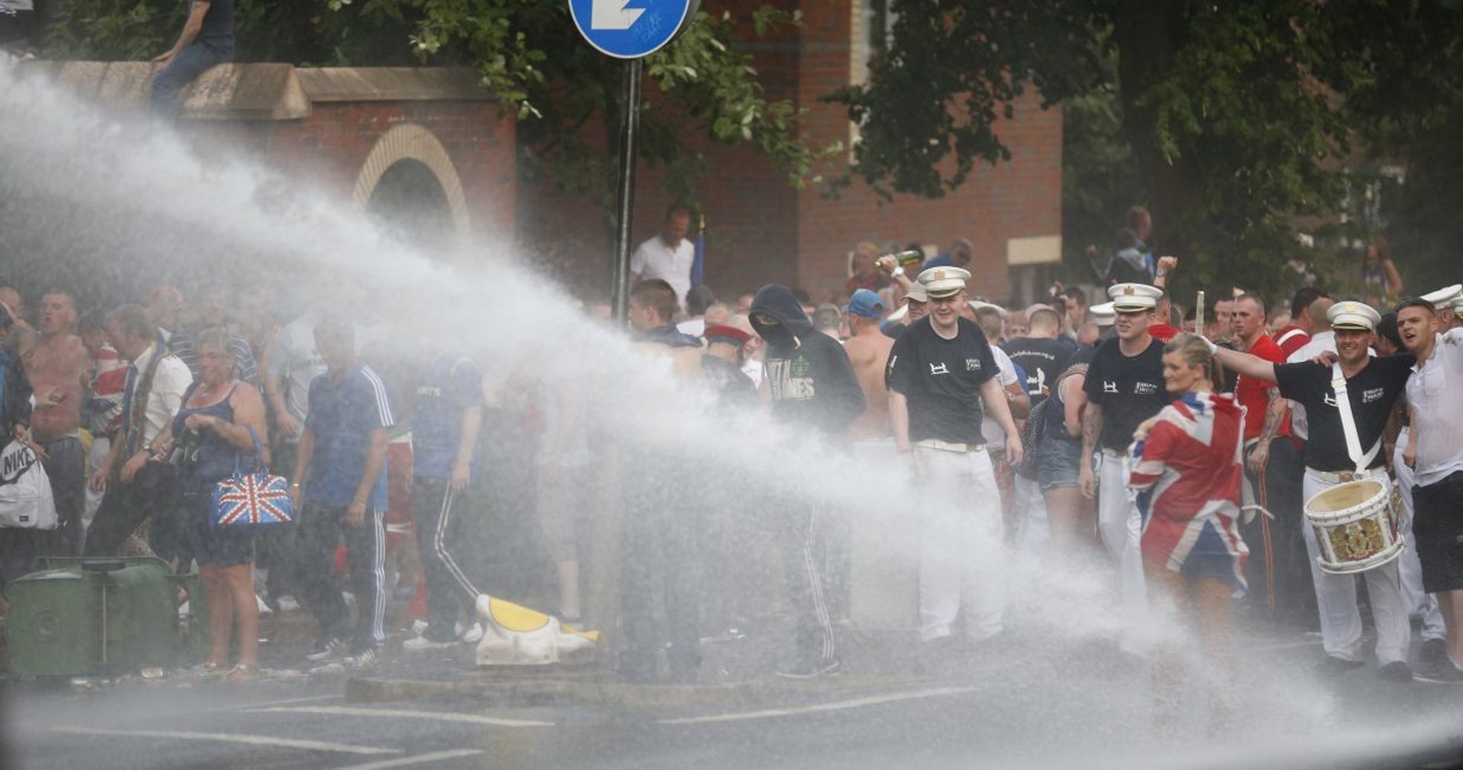 A police water cannon is directed at loyalists during rioting close to the Ardoyne area of North Belfast in 2013