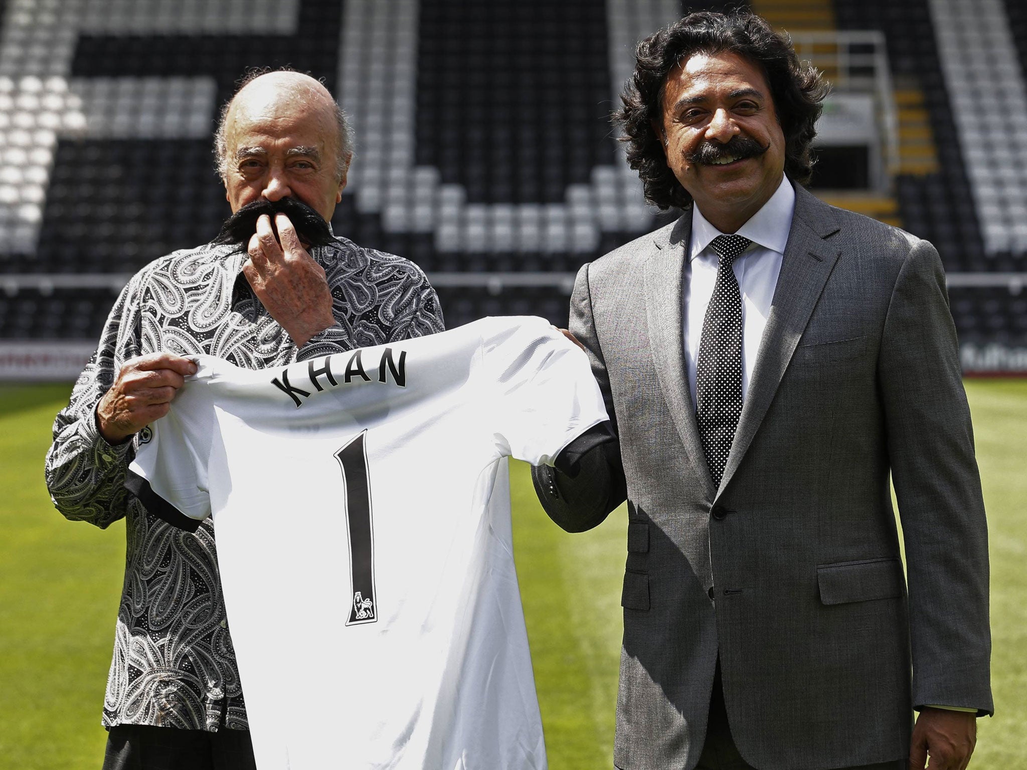 Lip service: Mohamed Al Fayed (left) welcomes new Fulham owner Shahid Khan to Craven Cottage