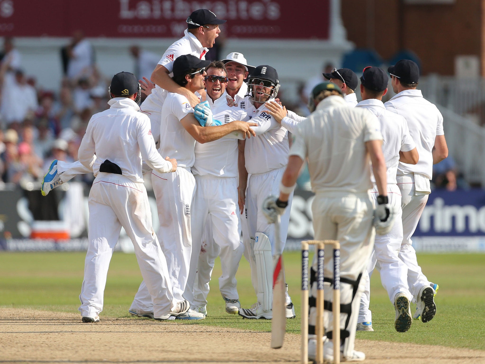 Closing in: Graeme Swann is mobbed after trapping Steve Smith lbw just one ball after Michael Clarke was caught behind