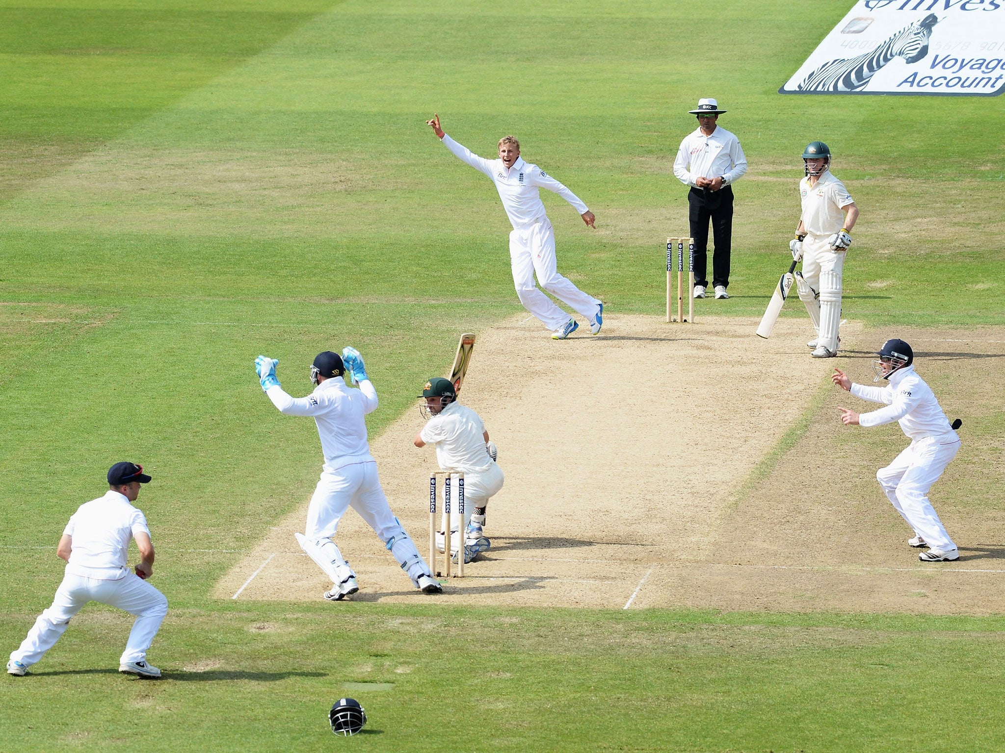 Root to success: Ed Cowan edges a delivery from Joe Root to Jonathan Trott at slip to the delight of the fielders