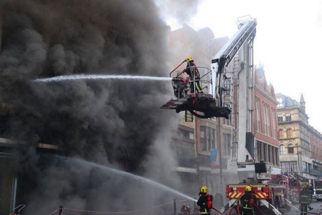 Greater Manchester Fire and Rescue Service of firefighters tackling a major fire in a shop in Manchester city centre