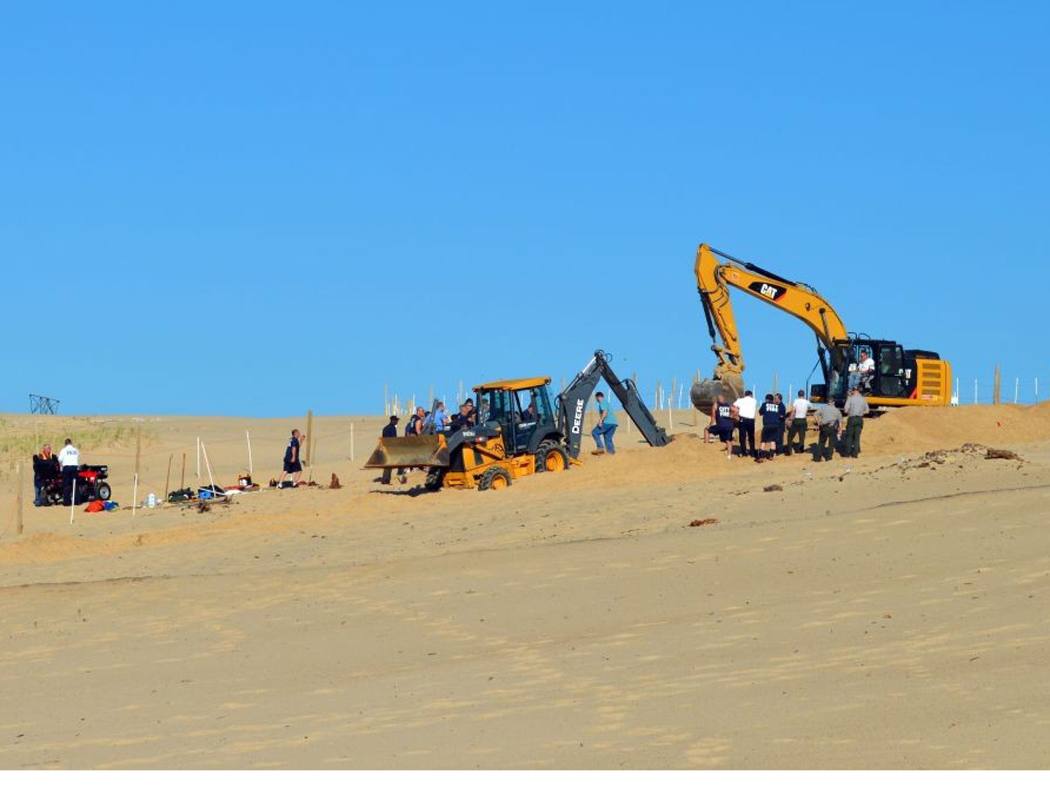Firefighters, police and first responders spent three hours digging to rescue a six-year-old boy trapped by a sand dune
