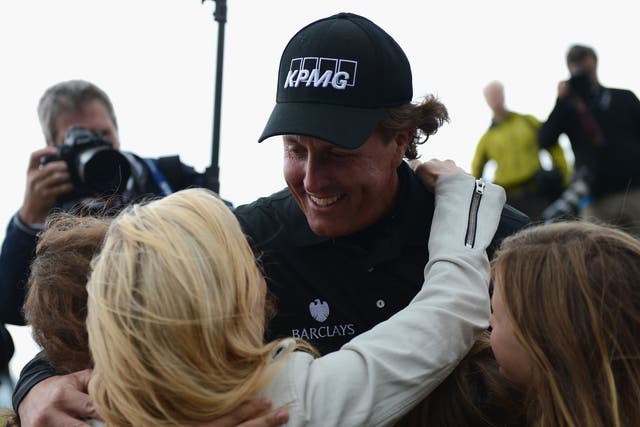 A jubilant Phil Mickelson celebrates winning with his family