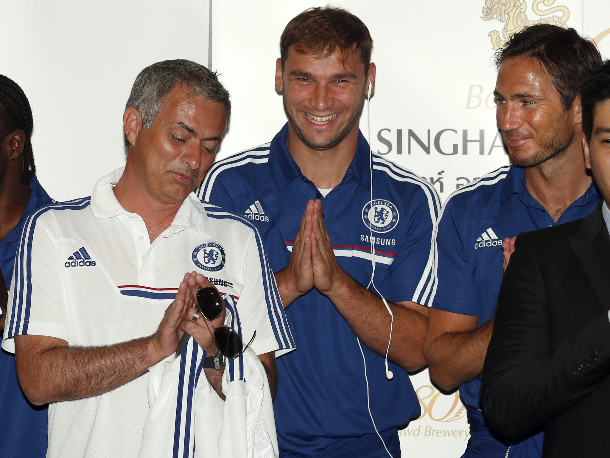 Jose Mourinho, left, jokes with Branislav Ivanovic and Frank Lampard, right, after arriving in Bangkok on Friday