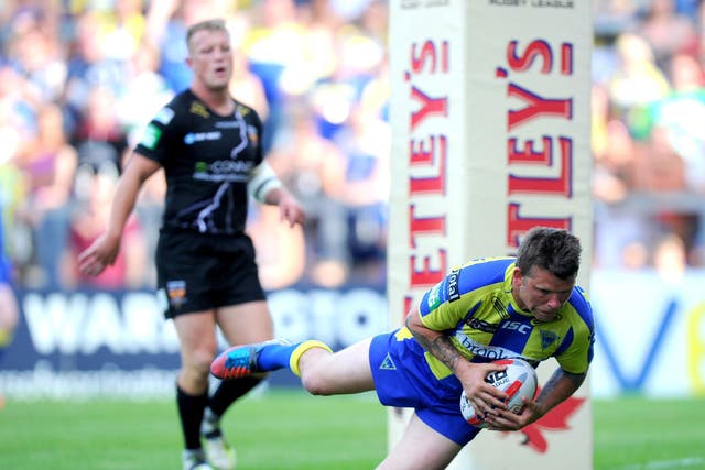 Warrington’s Lee Briers goes over for a try against Huddersfield