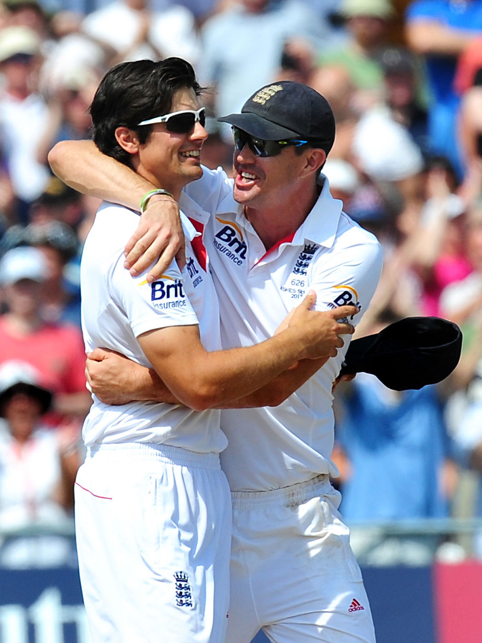 Alastair Cook, left, celebrates with Kevin Pietersen, right