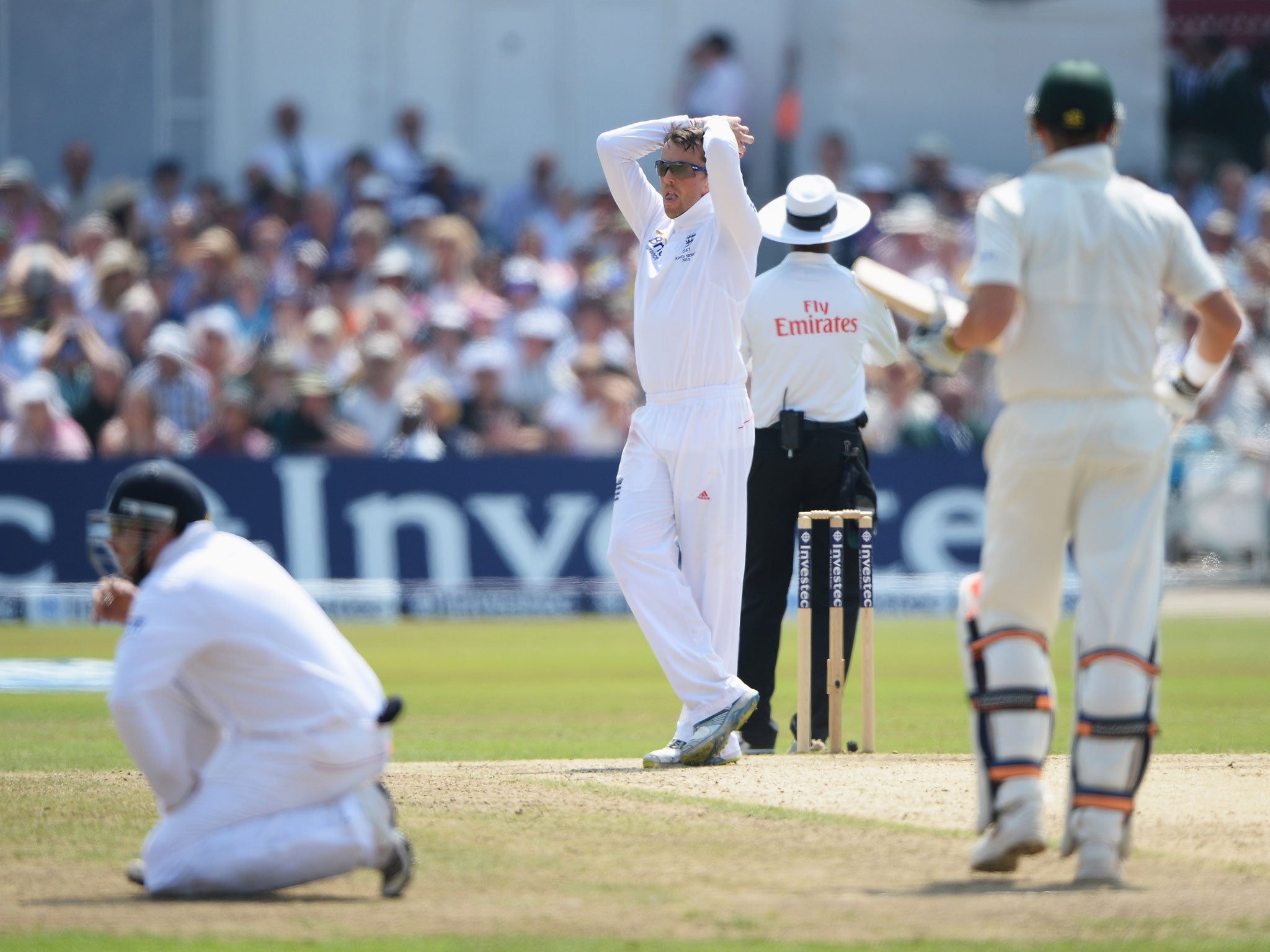 Graeme Swann reacts after seeing Steven Finn drop a catch to dismiss Brad Haddin