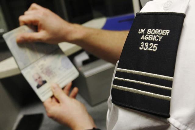 A UK Border Agency worker poses with a passport during a demonstration of the new facial recognition gates at the North Terminal of Gatwick Airport near London, November 23, 2009. The gates can be used by any British or EEA national who holds a biometric 