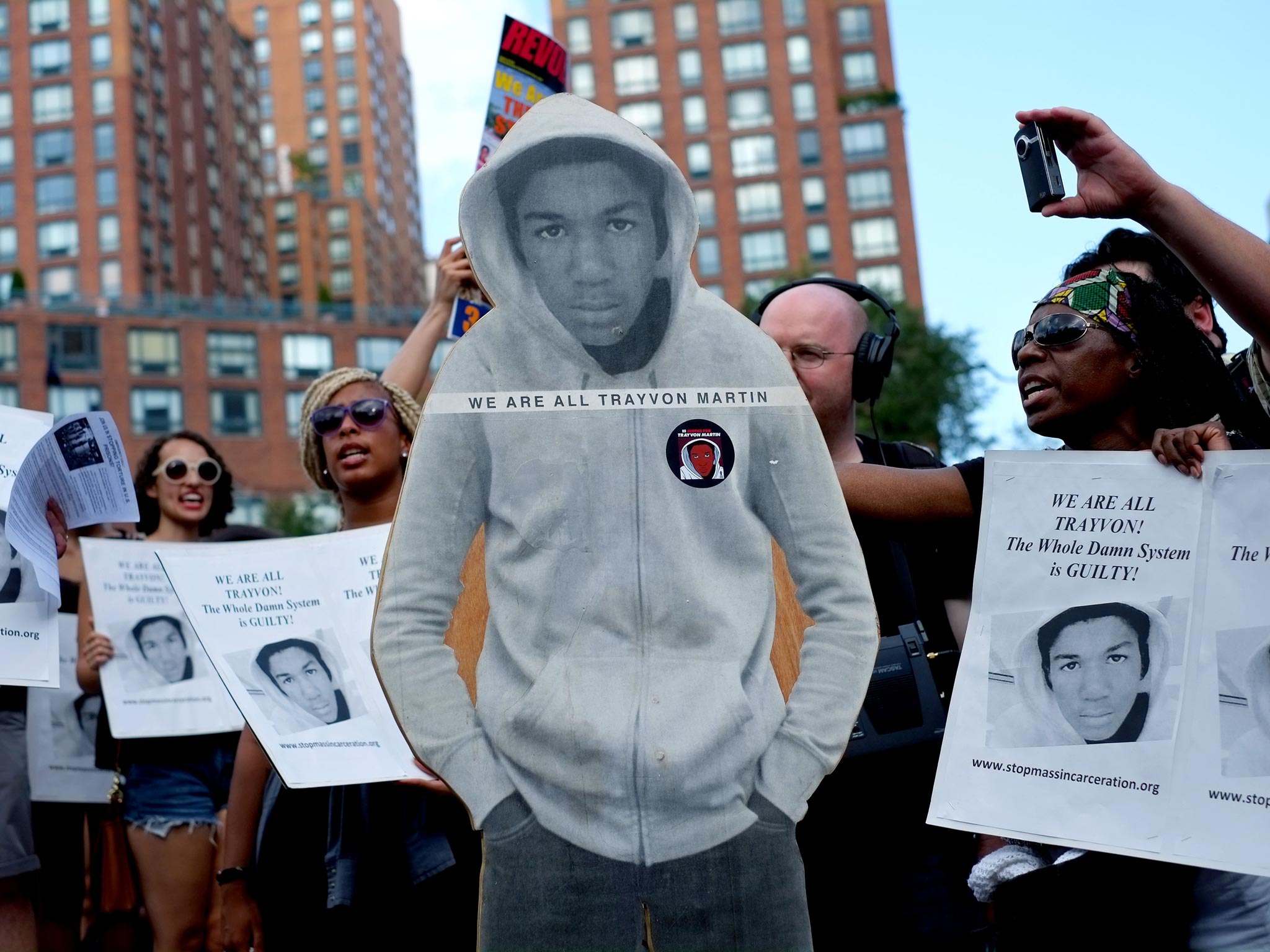 Activists on Union Square stand with a cut out photo of Trayvon Martin in New York