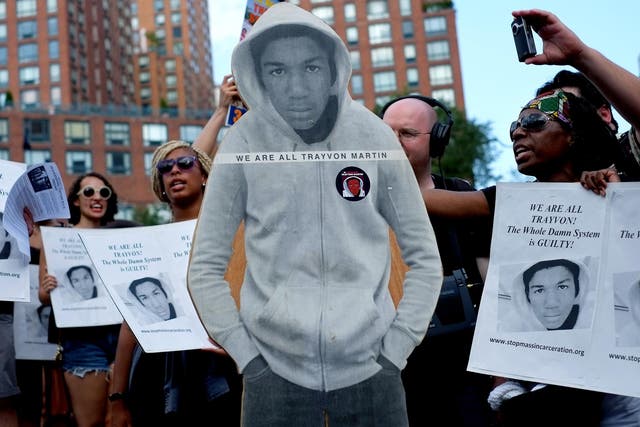 Activists on Union Square stand with a cut out photo of Trayvon Martin in New York