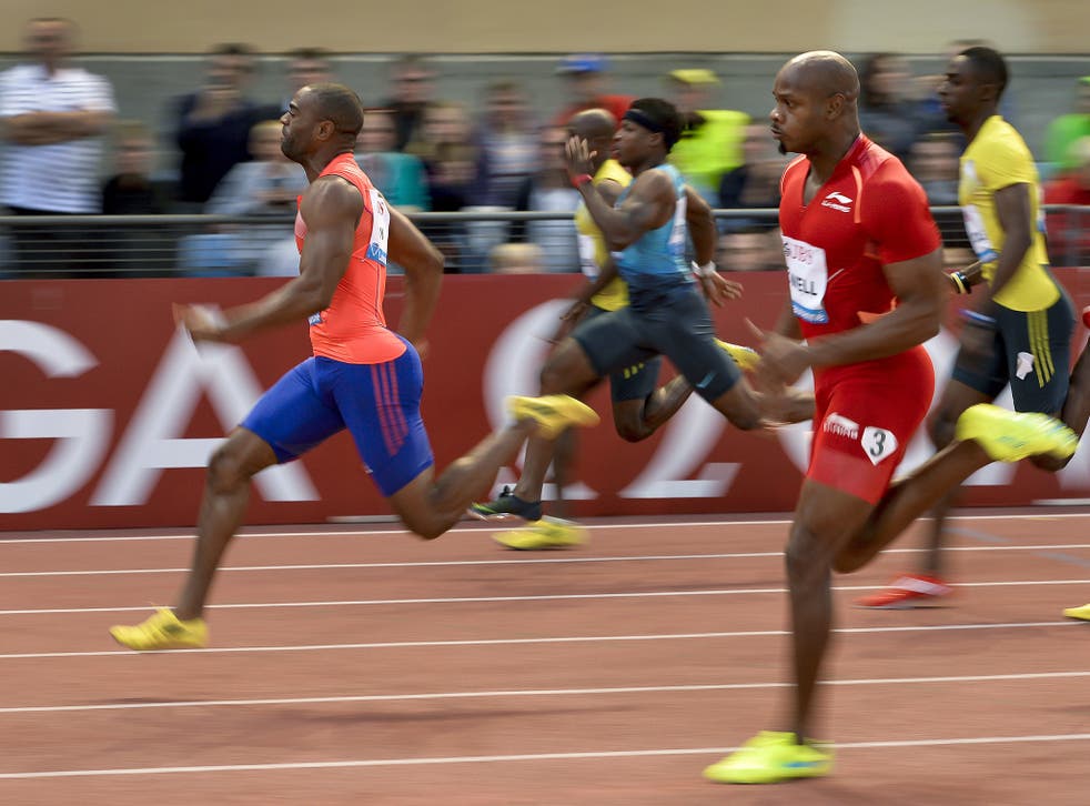 Tyson Gay (l) leads Asafa Powell (r) during the 100m event of the Diamond League Athletics meeting in Lausanne