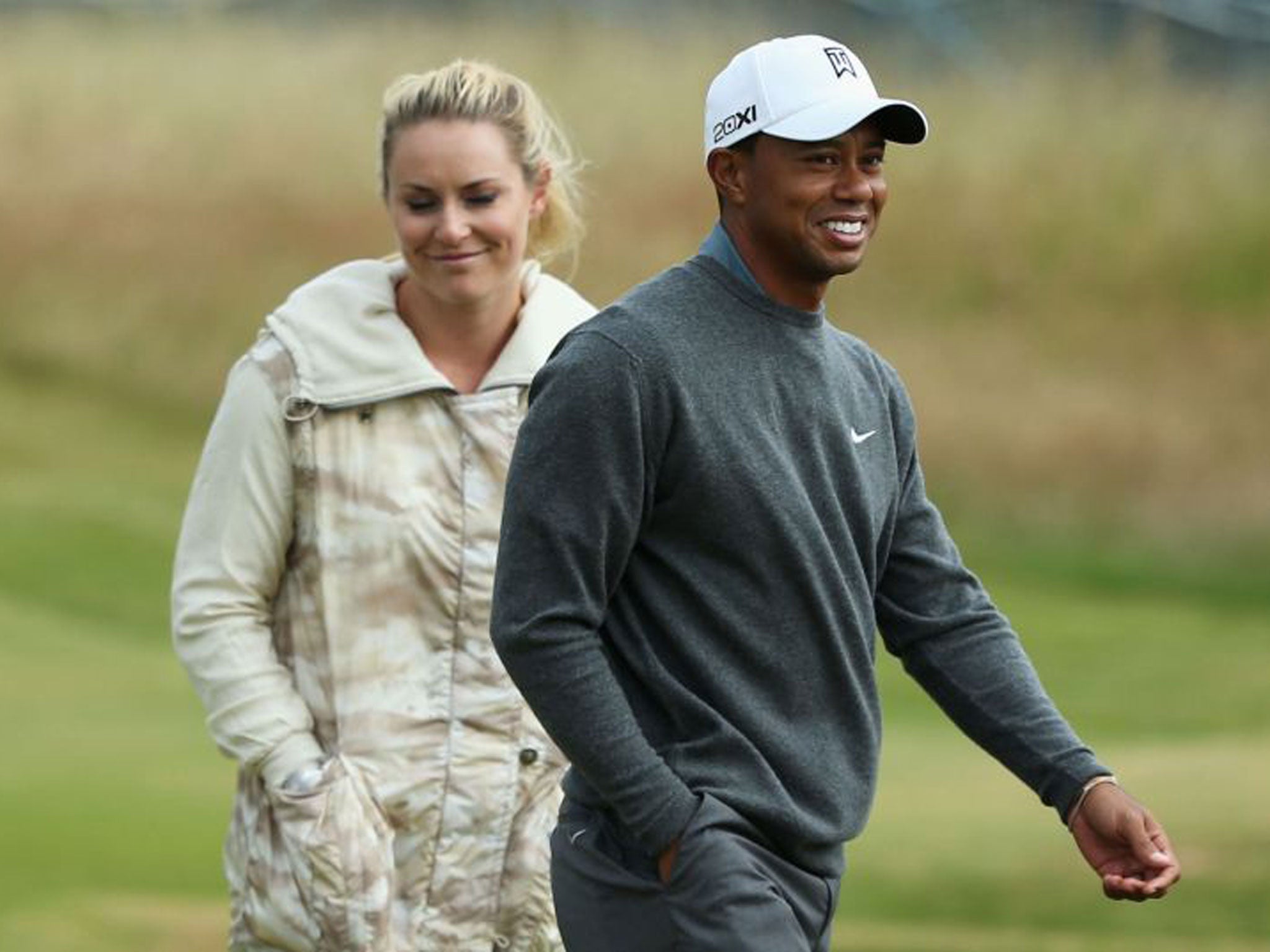 Tiger Woods and his partner, the skiier Lindsey Vonn, are all smiles as they walk the course ahead of this week’s Open at Muirfield