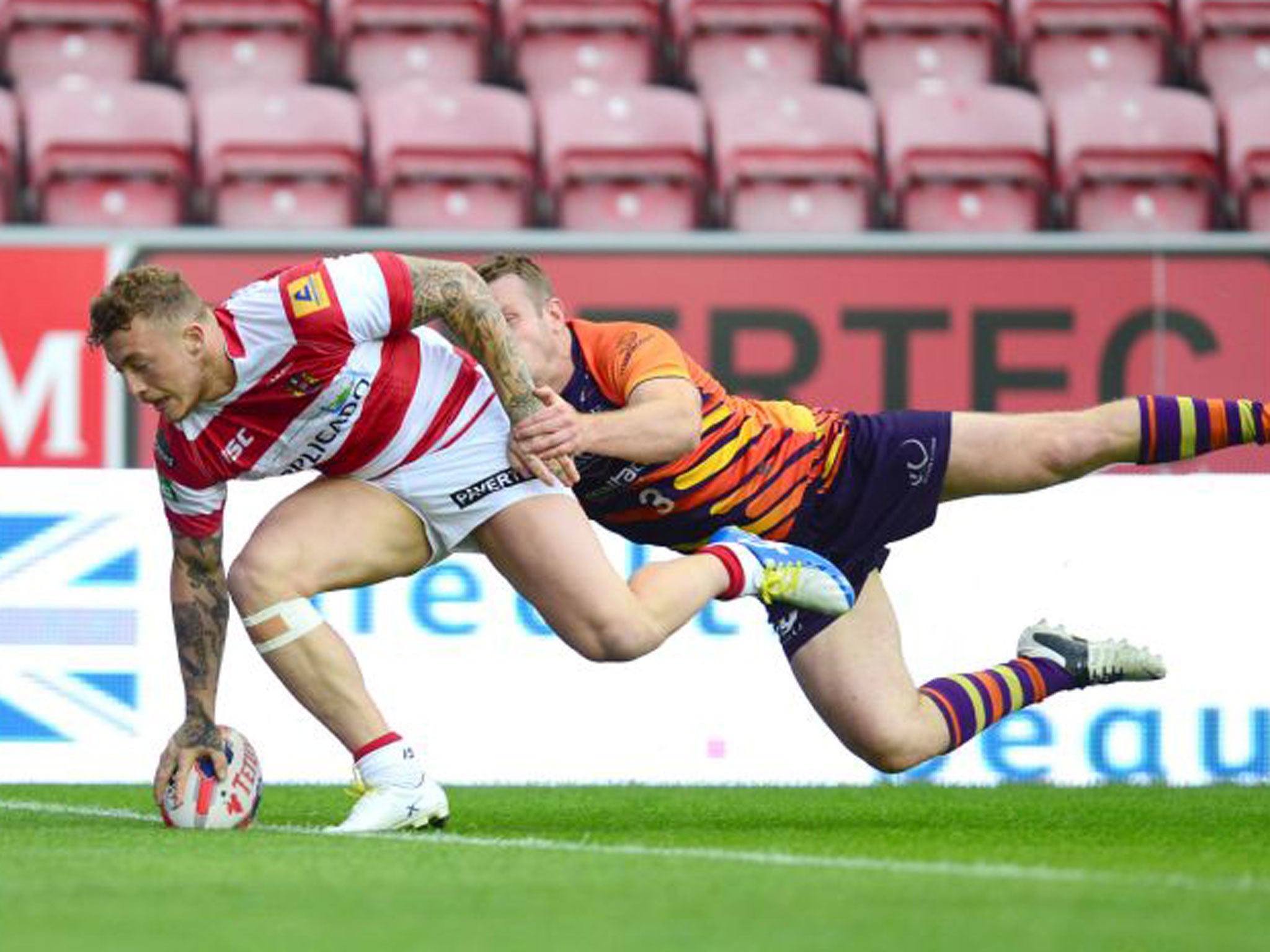 Wigan’s Josh Charnley crosses over for one of his three tries