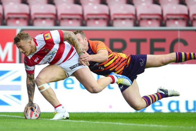 Wigan’s Josh Charnley crosses over for one of his three tries 