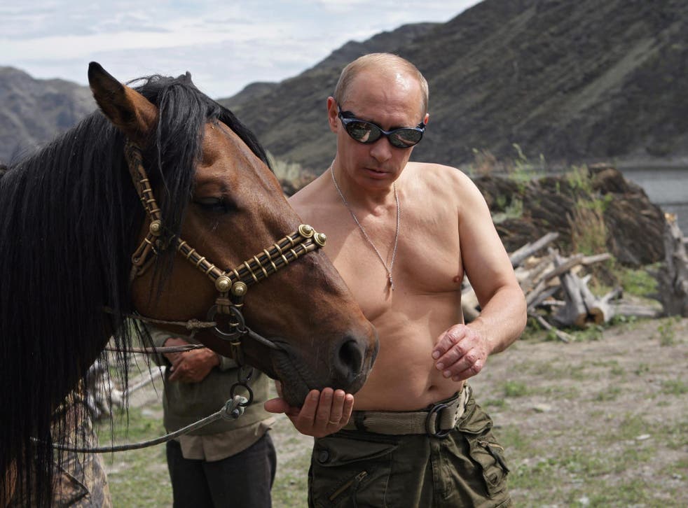 Russian Prime Minister Vladimir Putin feeds a horse during his vacation in the Republic of Tyva, Russia, in August 2009