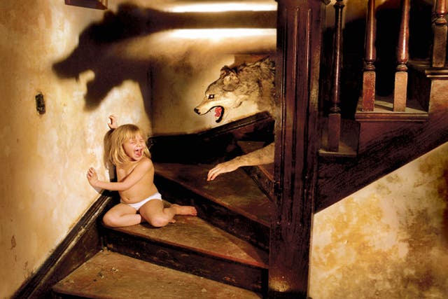 Joshua Hoffine identified his most controversial image as being that of a cornered nappy-wearing child screaming as a wolf approaches her on a staircase. 'This one I get hate mail for- it crosses the line for so many people. The wolf is universally read as a sexual predator,' he said