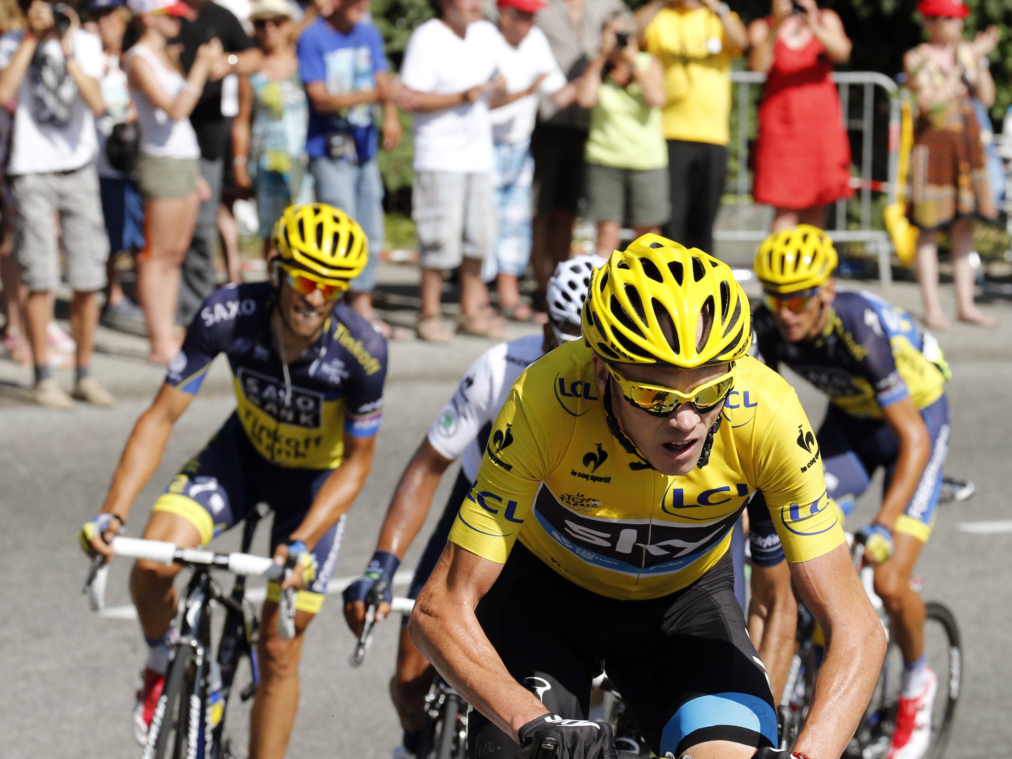 Overall leader Chris Froome (C) rides ahead of Spain's Alberto Contador (L) in the pack during the 168 km sixteenth stage of the 100th edition of the Tour
