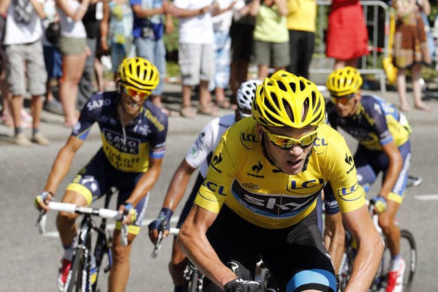 Overall leader Chris Froome (C) rides ahead of Spain's Alberto Contador (L) in the pack during the 168 km sixteenth stage of the 100th edition of the Tour 