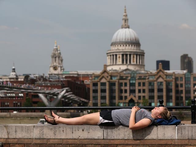 Sunbathing by the Thames as the heatwave continues in London and across much of the UK