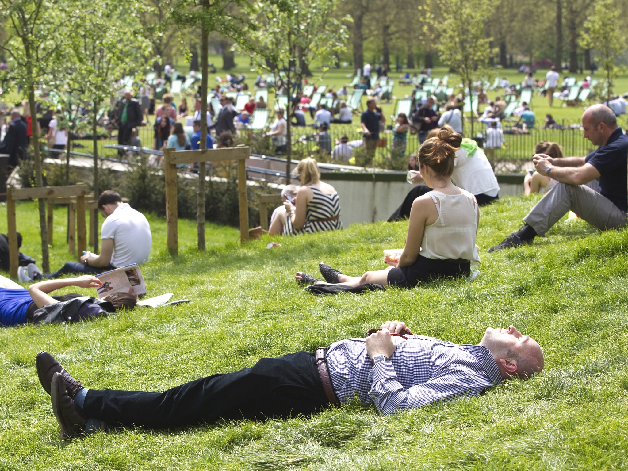 Londoners sunbathing during their lunch hour in Green Park