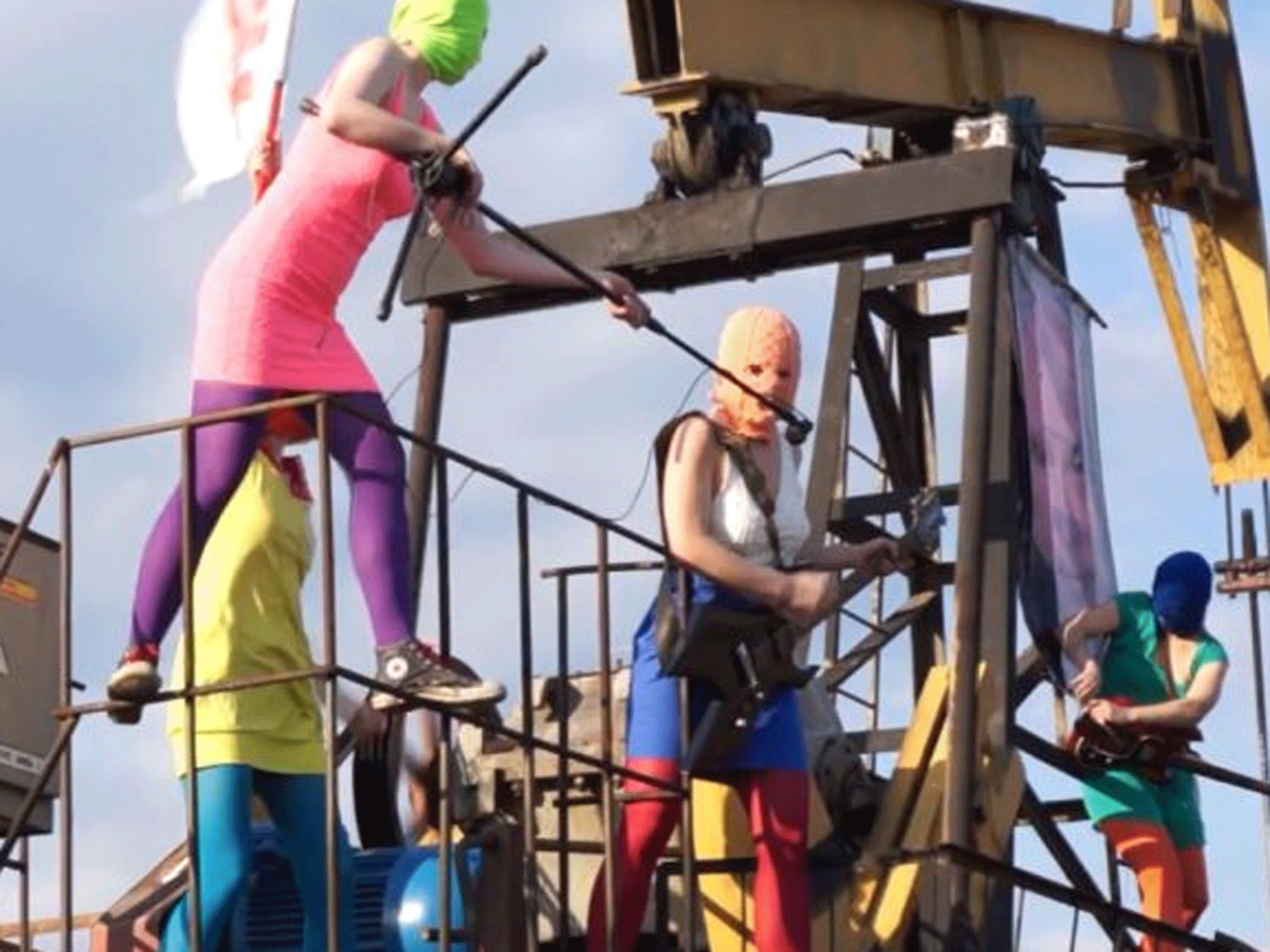 Pussy Riot new video provided on Tuesday, 16 July 2013, shows the band members in trademark bright-colored ski masks performing on top of an oil rig
