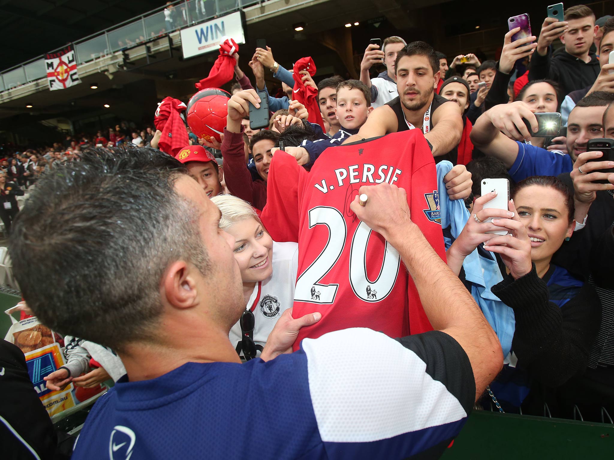 Robin van Persie of Manchester United signs autographs after a first team training session at Kogarah