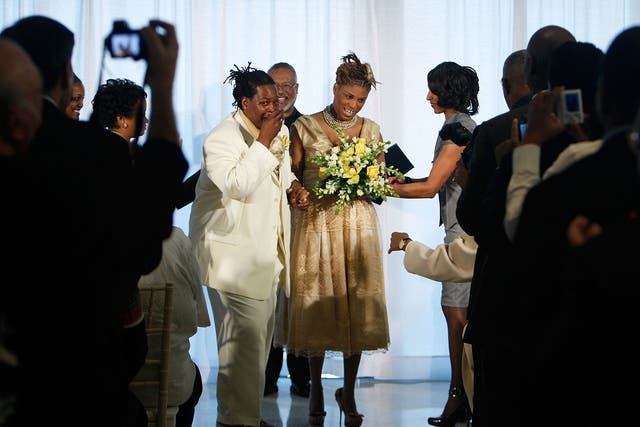 Angelisa Young (R) and Sinjoyla Townsend (L) rejoice as Rev. David North (C) looks on during their wedding on the first day same-sex couples are legal to wed under a new law March 9, 2010 in Washington, DC.