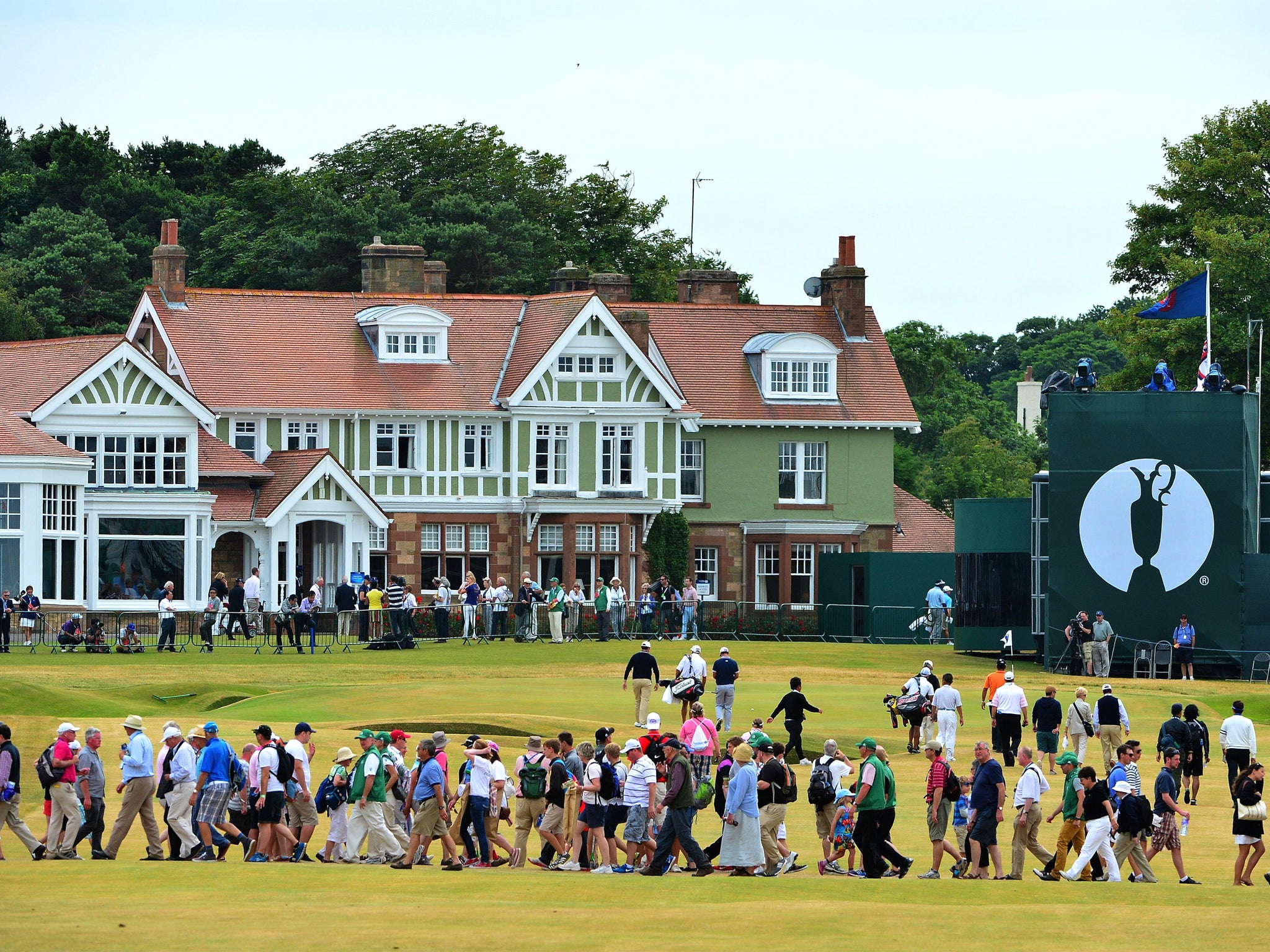 Golf fans make their way across the 18th fairway during practice for the Open Championship at Muirfield