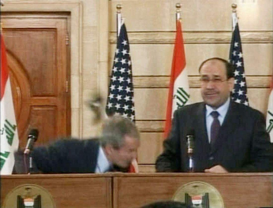 Video frame grab of U.S. President George W. Bush (L) ducking from a shoe during a news conference in Baghdad December 14, 2008. REUTERS/Reuters TV