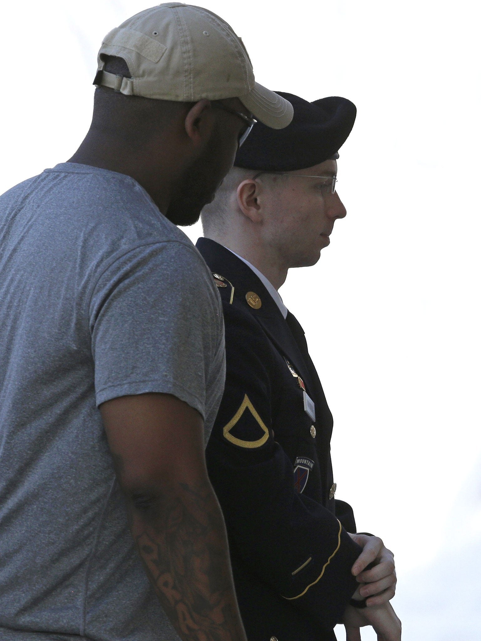 Bradley Manning is escorted into a courthouse before a court martial hearing