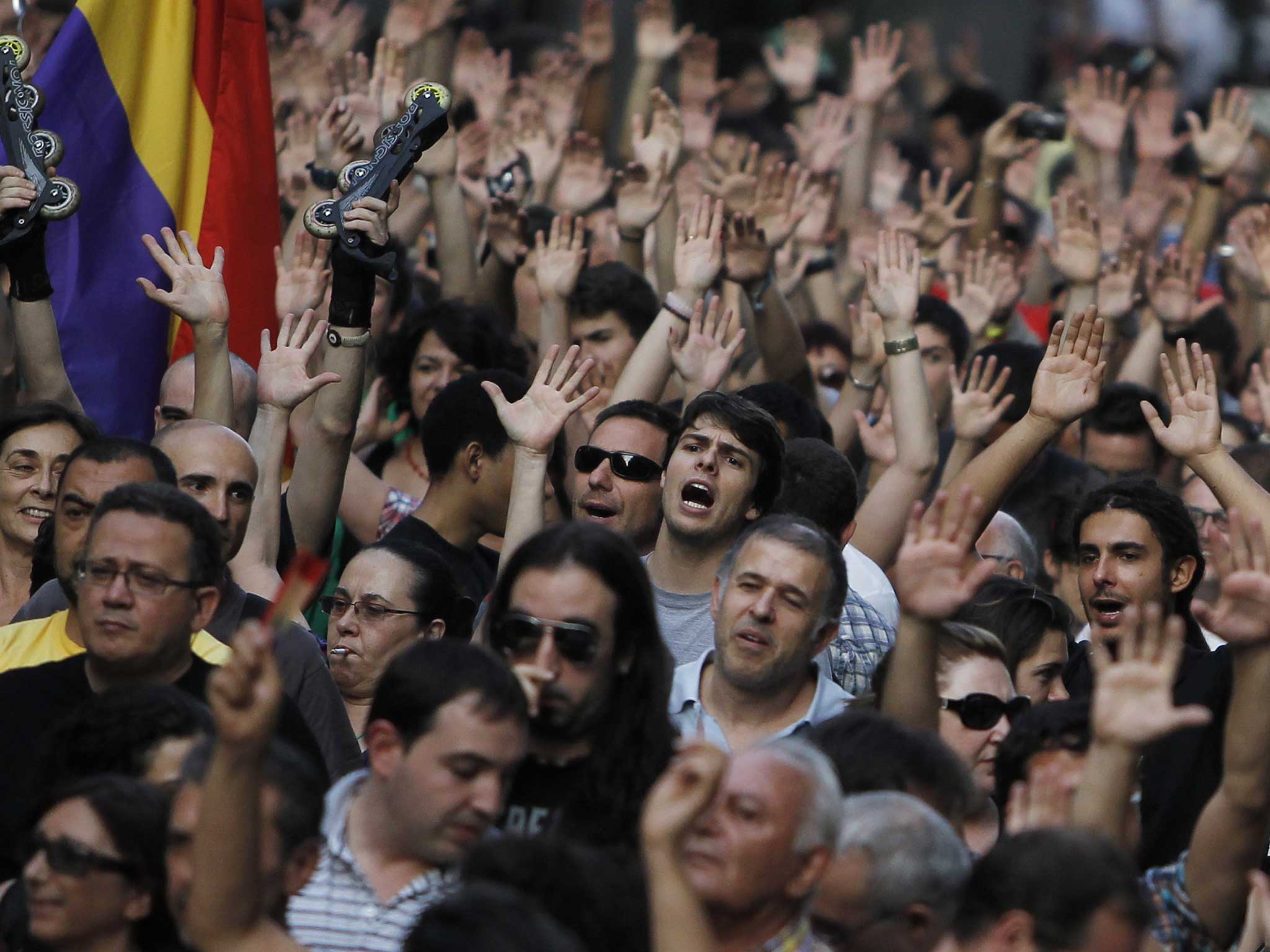 Protesters shout slogans during a demonstration against the Spanish government