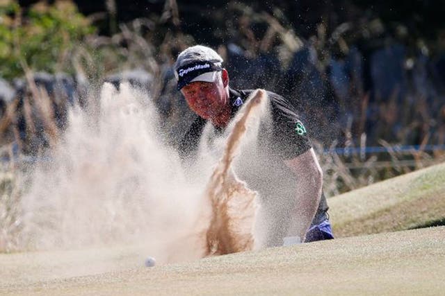 Darren Clarke thrashes around in the bunker on the sixth on his way to a quadruple bogey eight
