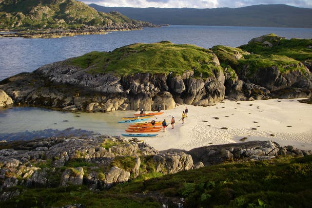 Safe and sound: Kayakers catch their breath on the shores of the tidal island of Eilean Shona in Loch Moidart