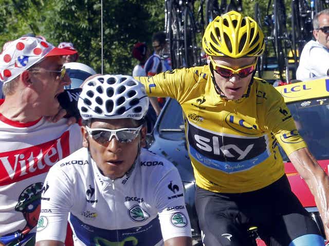 Shove off: Froome (yellow jersey) gives a spectator short shrift as he comes in behind stage winner Quintana