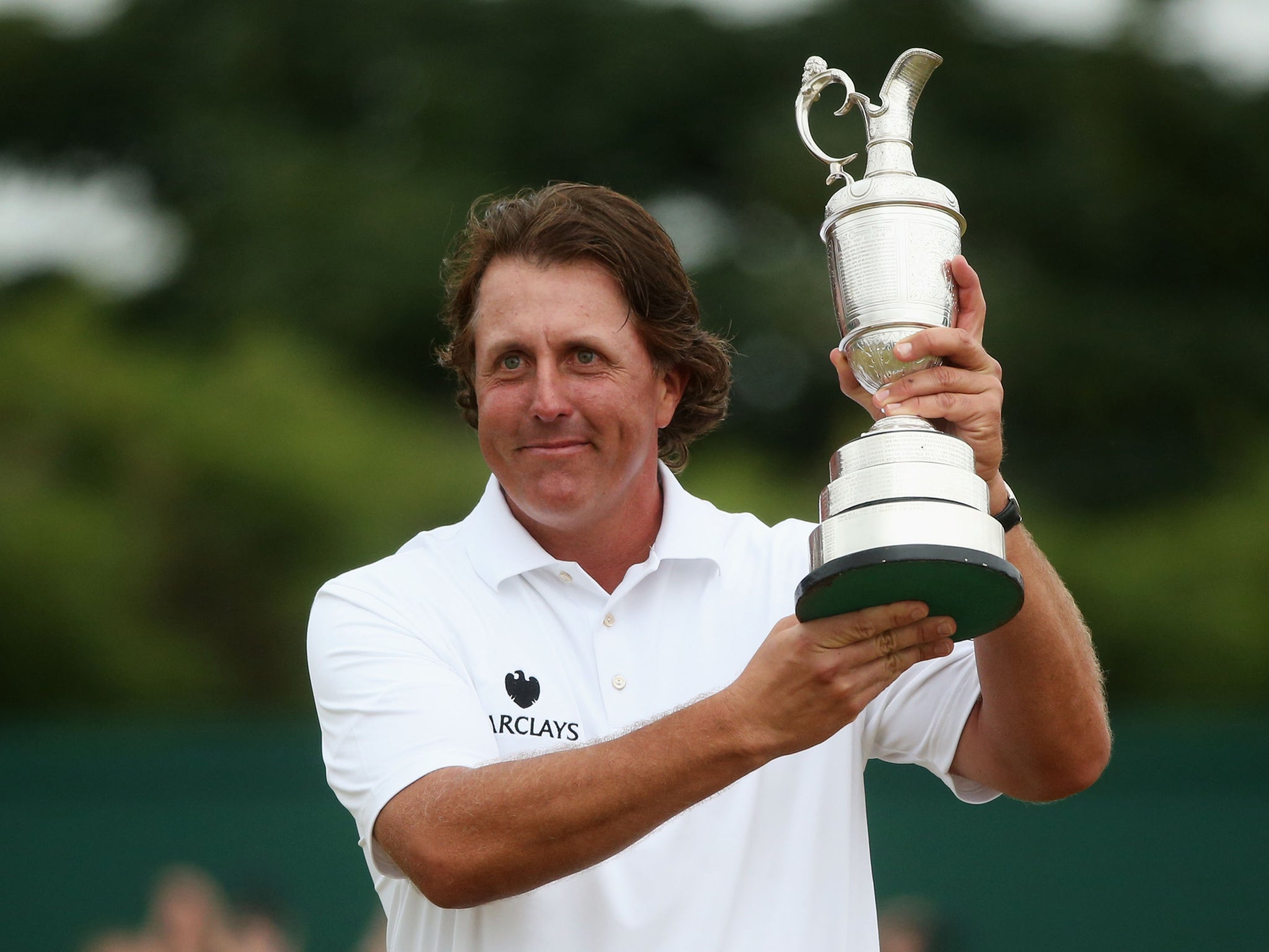 Phil Mickelson celebrates his Open Championship success by lifting the famous Claret Jug for the first time