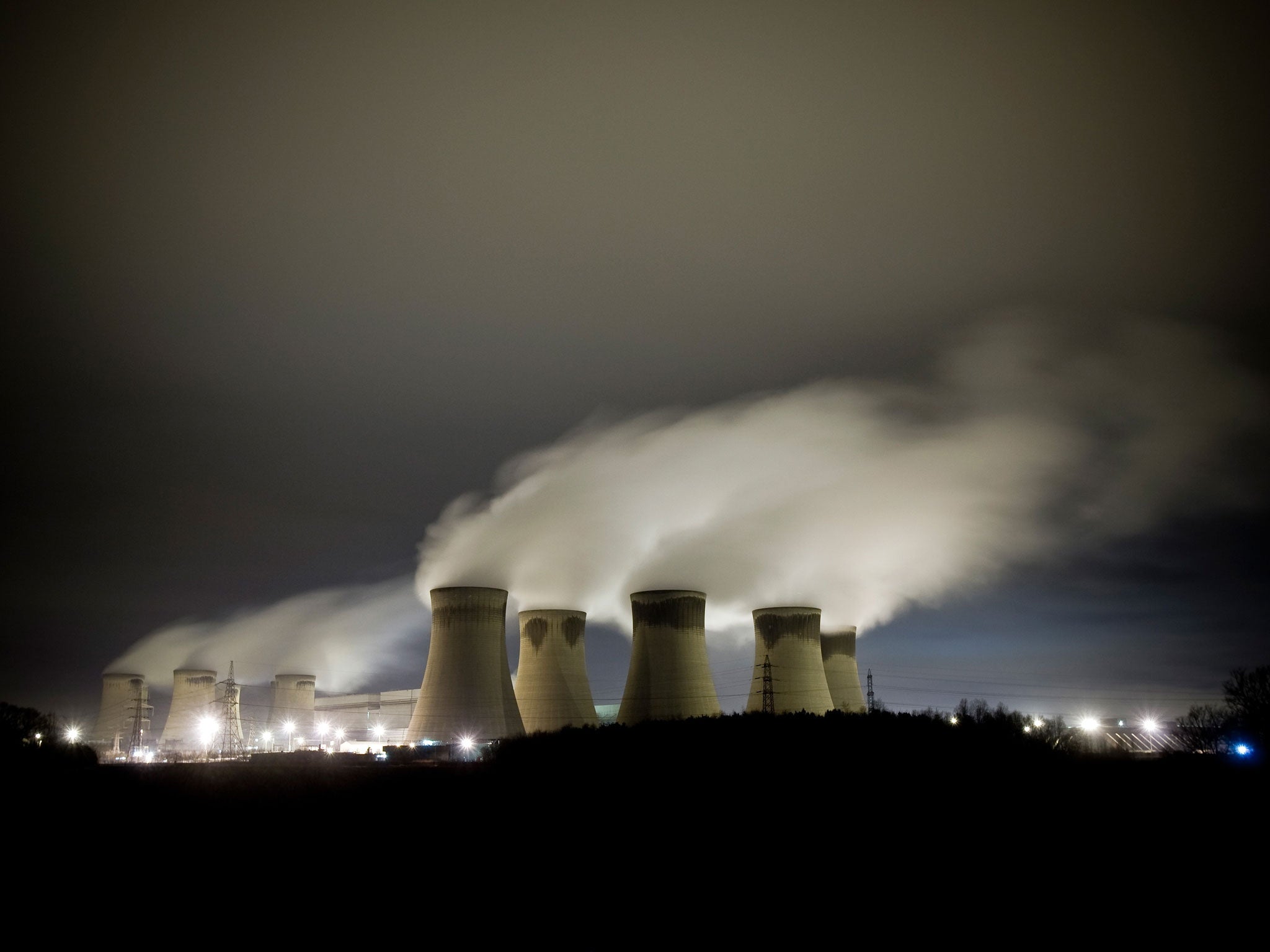 Steam rises from power station cooling towers