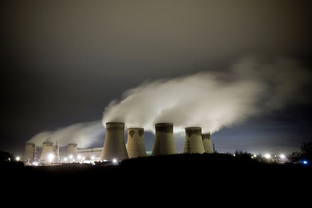 Steam rises from power station cooling towers